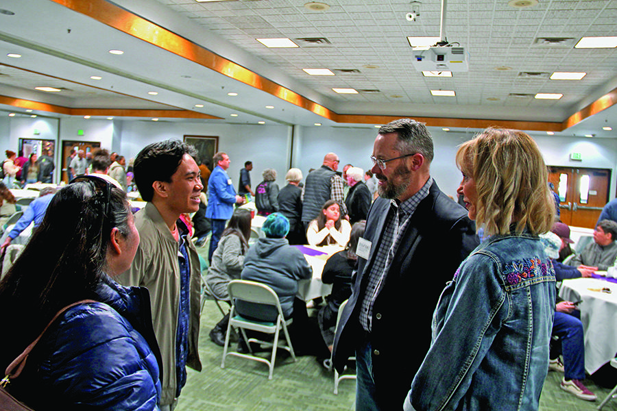 Four individuals chatting at the Scholarship reception