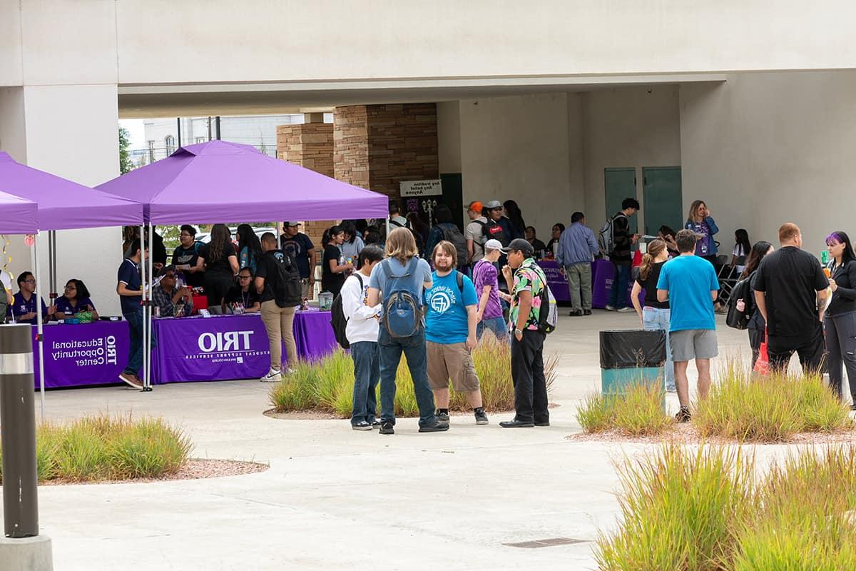 groups of students enjoying fall rush at Learning Commons Plaza