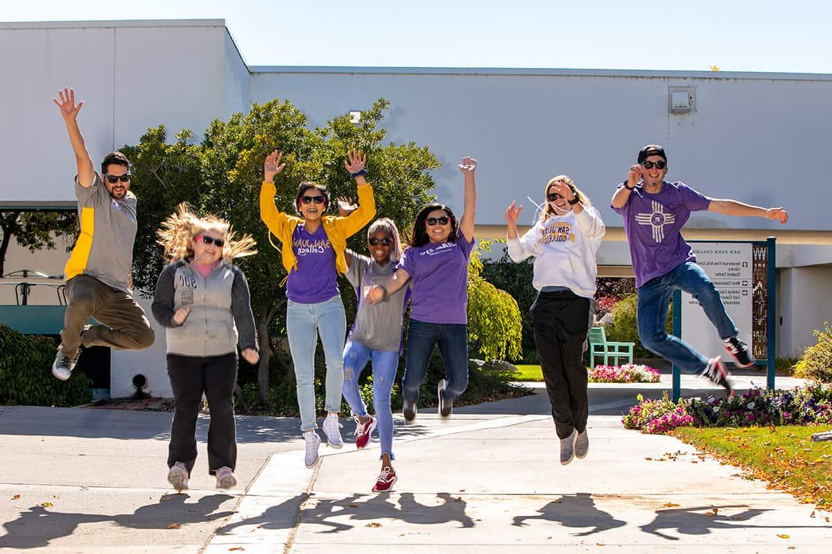 sjc students jumping and celebrating