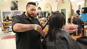 Cosmetologist cutting hair.