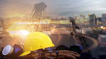 Hardhat with construction in the background.